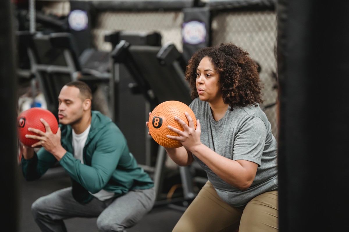 Man and woman crouched holding a ball