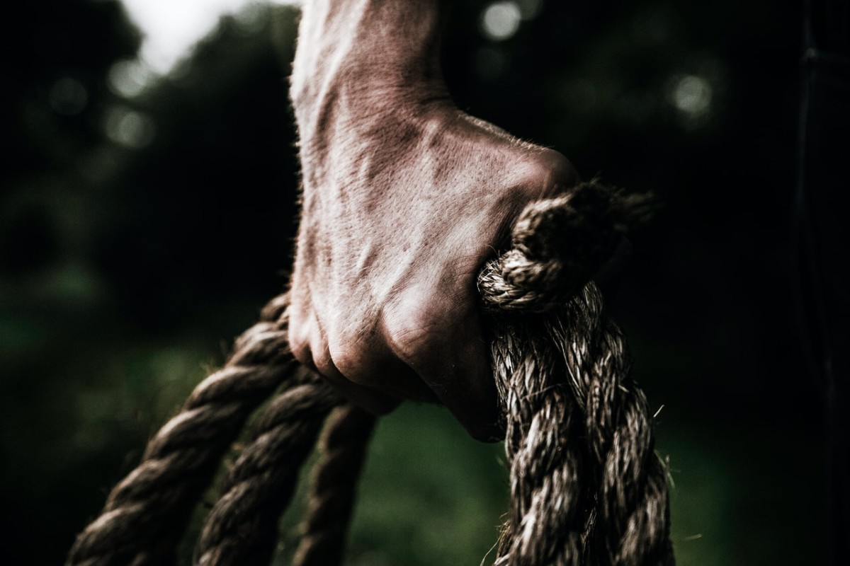 man grabbing rope