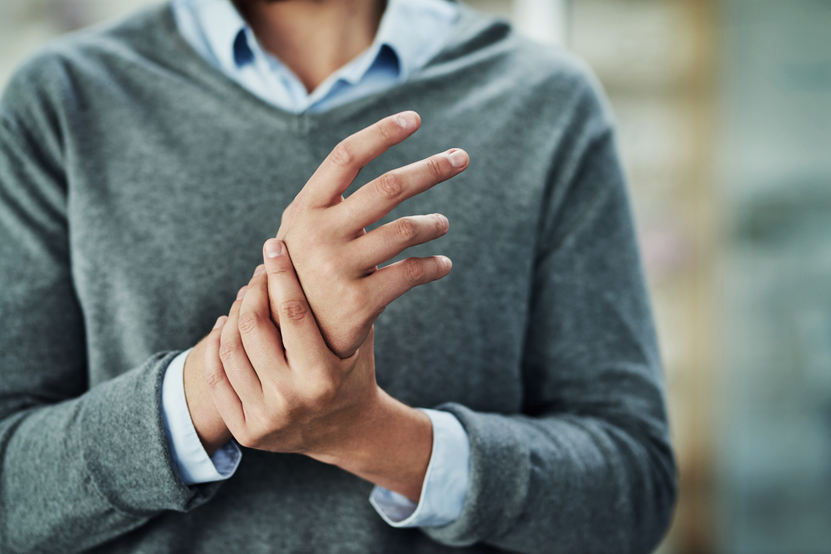 man holding his hand in pain