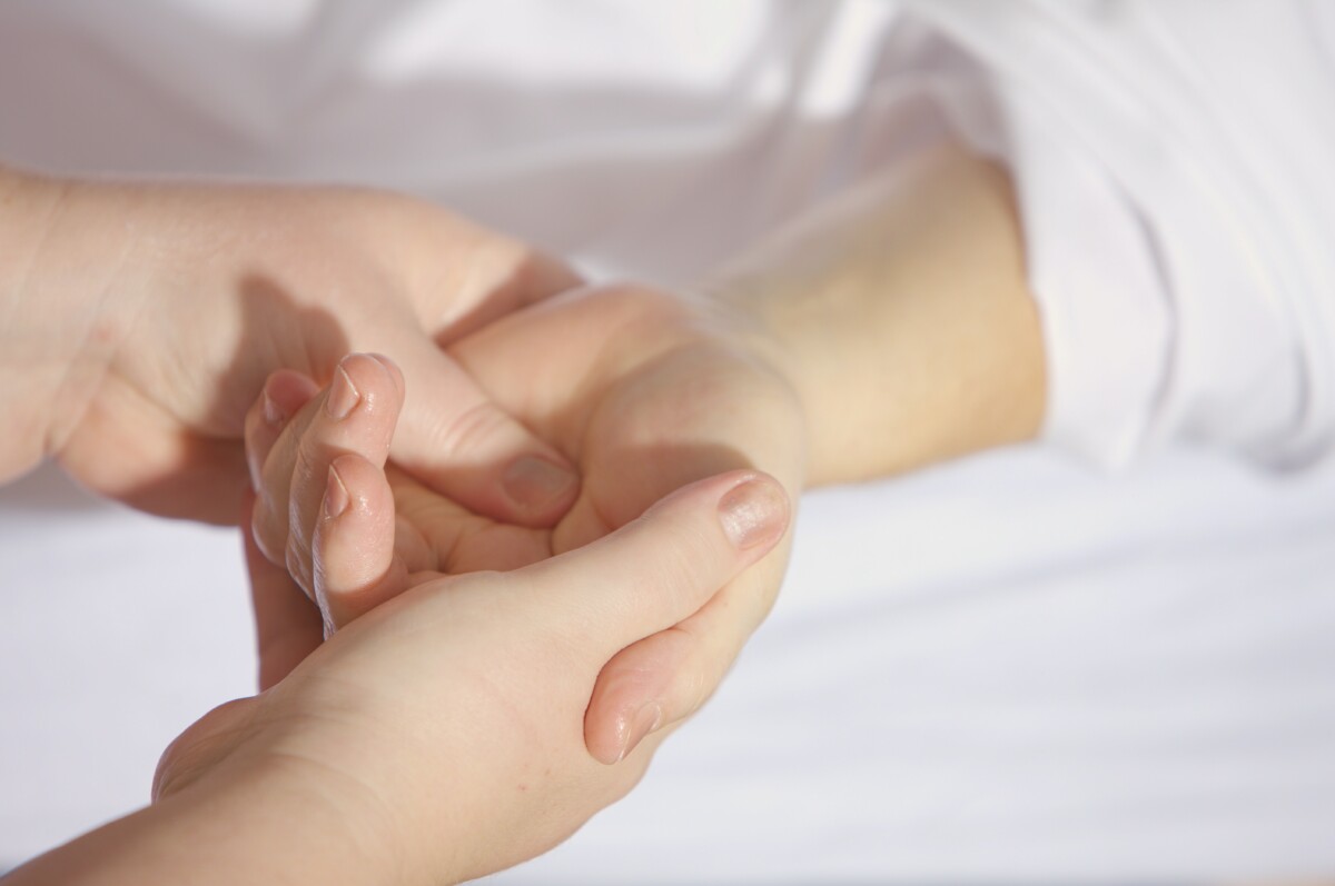 hand cupping another hand - managing arthritis in winter