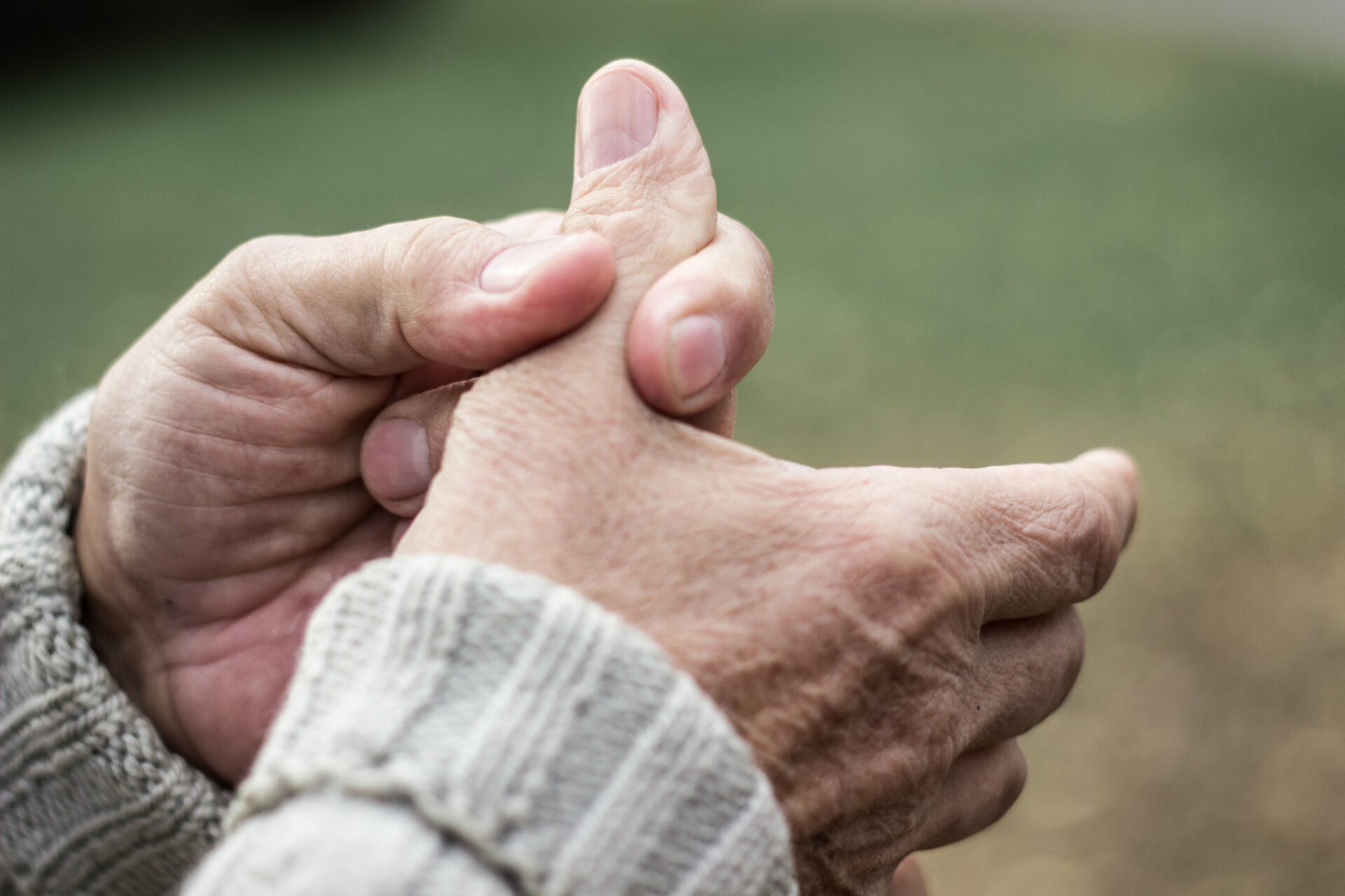 elderly man suffering with thumb arthritis